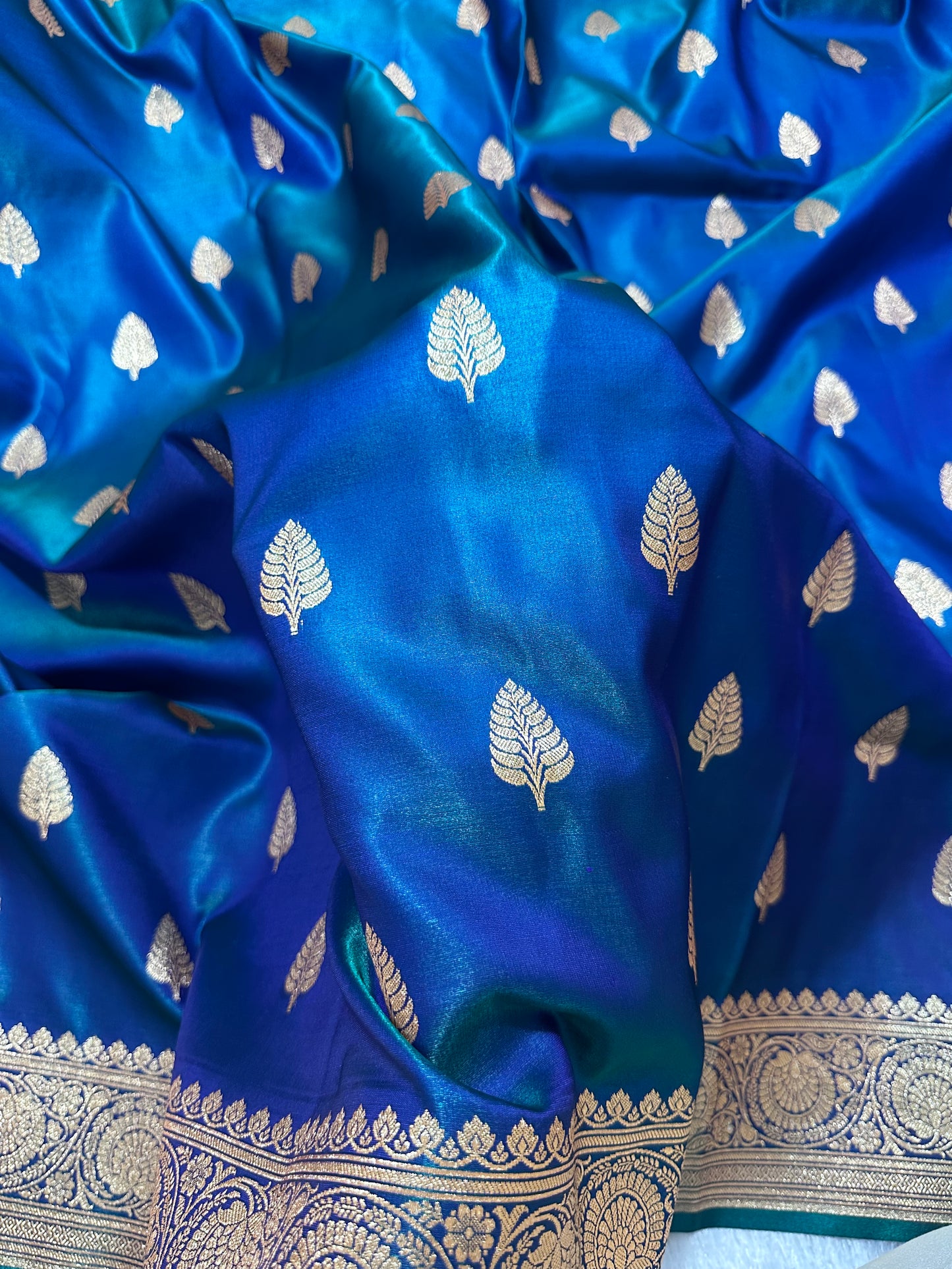 Royal Peacock Blue Satin Silk Banarasi Saree with Royal Guldasta Chakra Border and Bold Gold Panna Butis