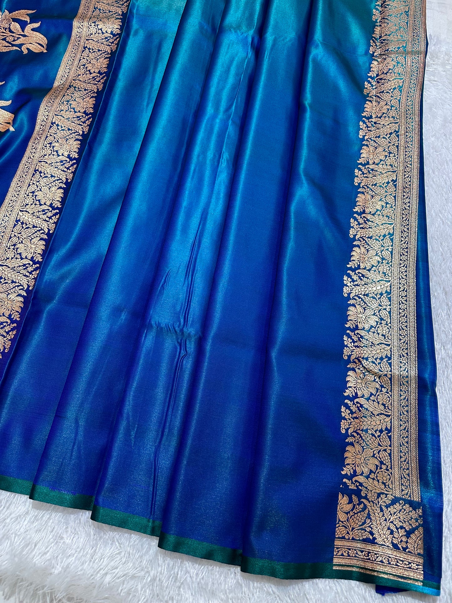 Royal Peacock Blue Satin Silk Banarasi Saree with Delicate Floral Arch Border and Traditional Kalka Butis