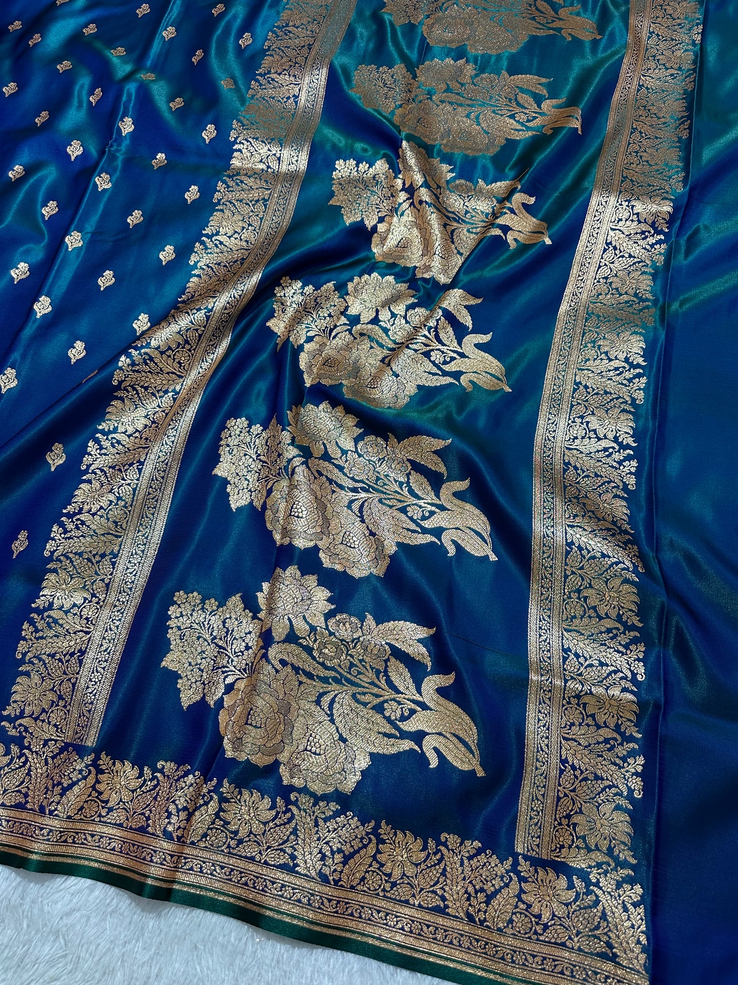 Royal Peacock Blue Satin Silk Banarasi Saree with Delicate Floral Arch Border and Traditional Kalka Butis
