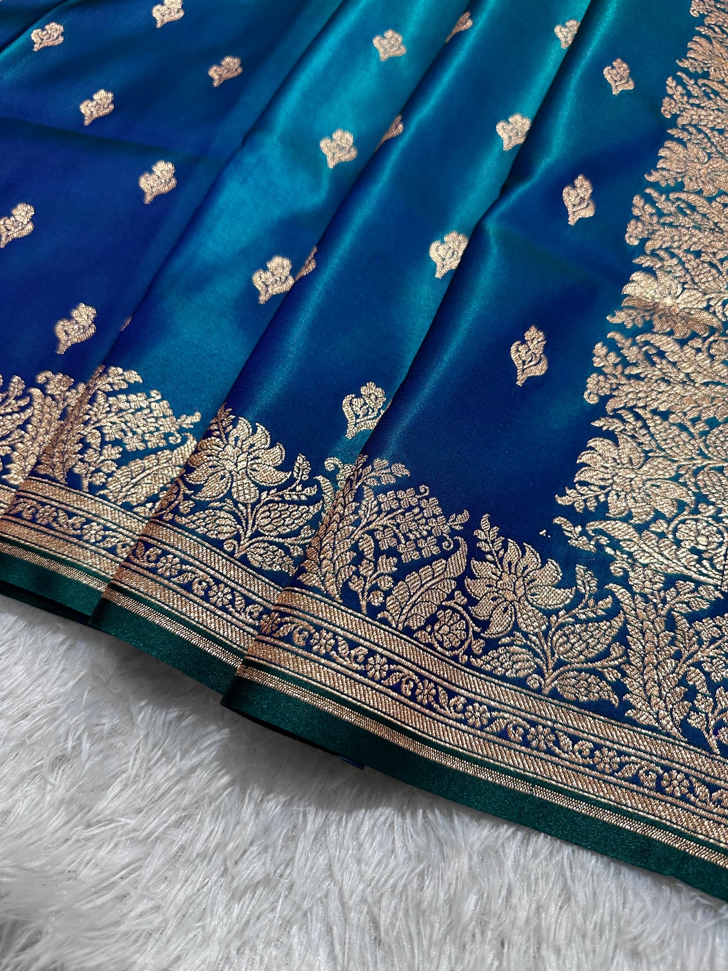 Royal Peacock Blue Satin Silk Banarasi Saree with Delicate Floral Arch Border and Traditional Kalka Butis